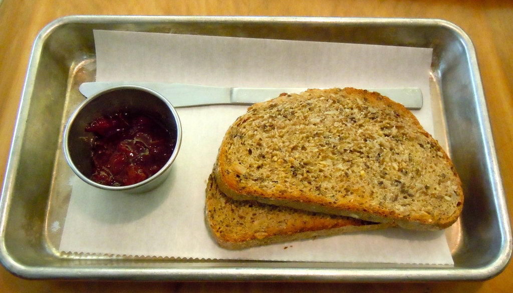 Artisanal toast: ten seed loaf, blueberry jam.